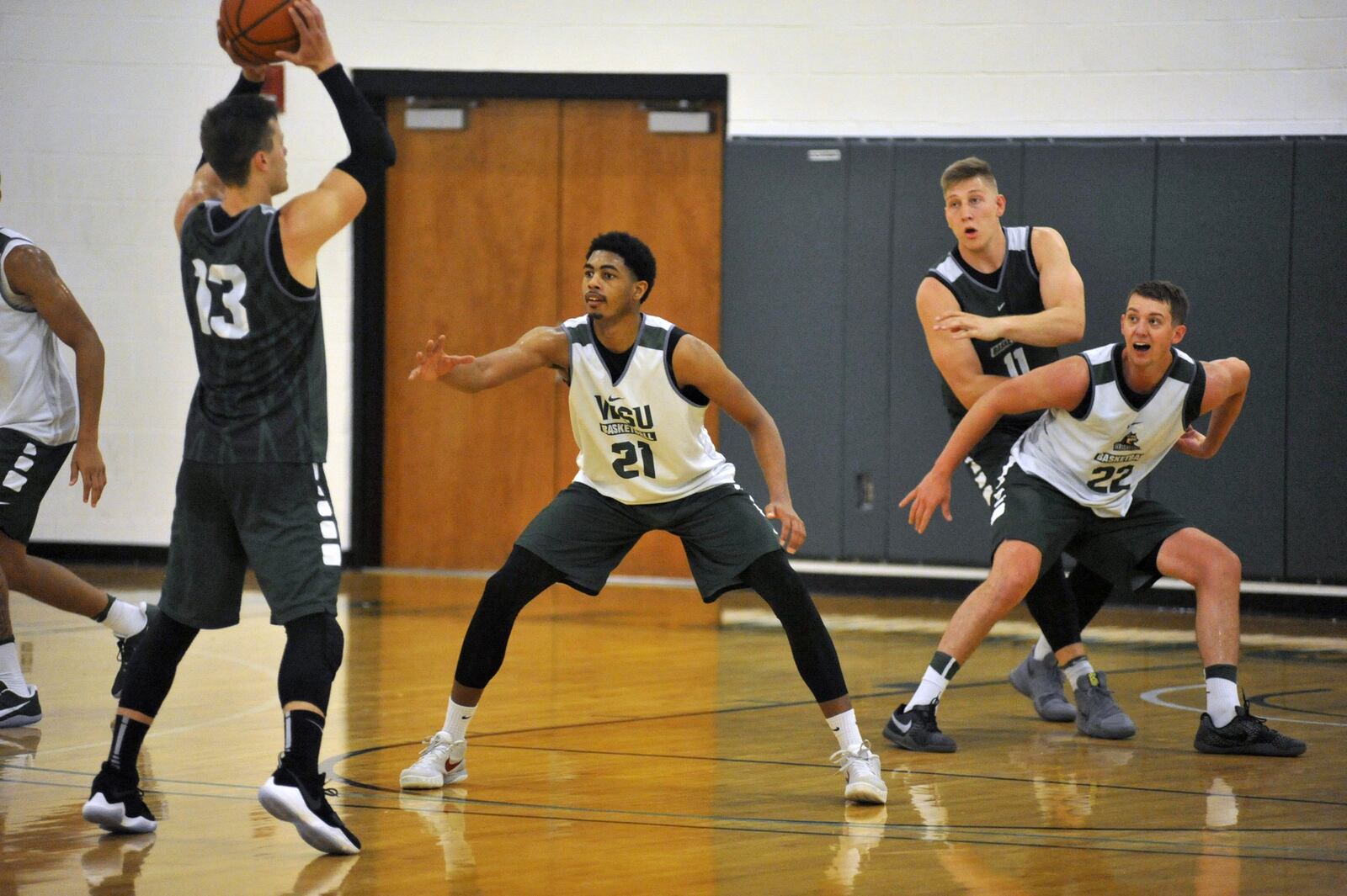 Wright State freshman James Manns (21) defends against senior Grant Benzinger during summer practice Thursday at the Setzer Pavilion.