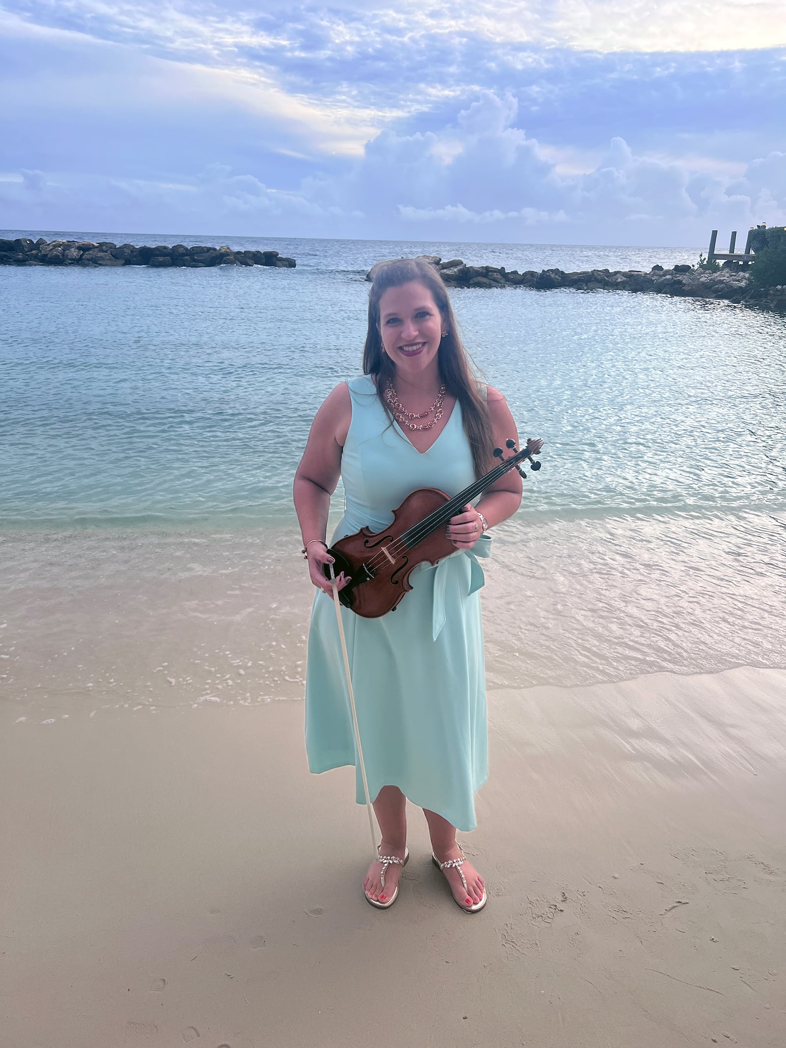 Abigael Kaszar with her violin at a destination wedding for a friend in 2023. Her mom, Anne Katherine, encouraged her daughter to take up the violin after her accident as a first grader. CONTRIBUTED