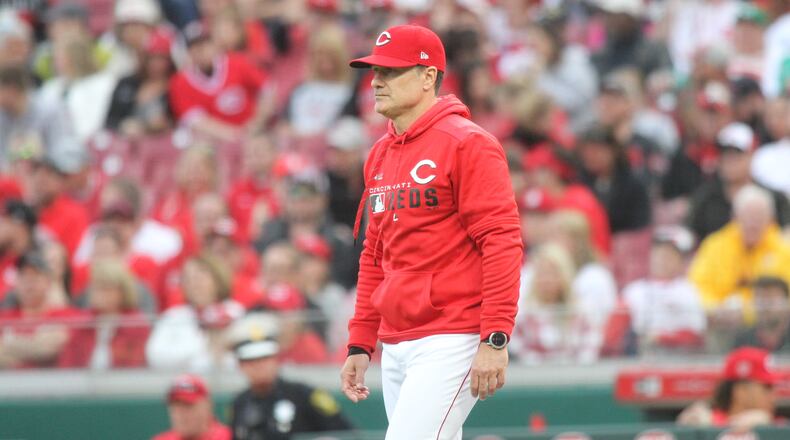 Reds manager David Bell walks to the mound to make a pitching change in the ninth inning against the Pirates on Opening Day on Thursday, March 28, 2019, at Great American Ball Park in Cincinnati. David Jablonski/Staff