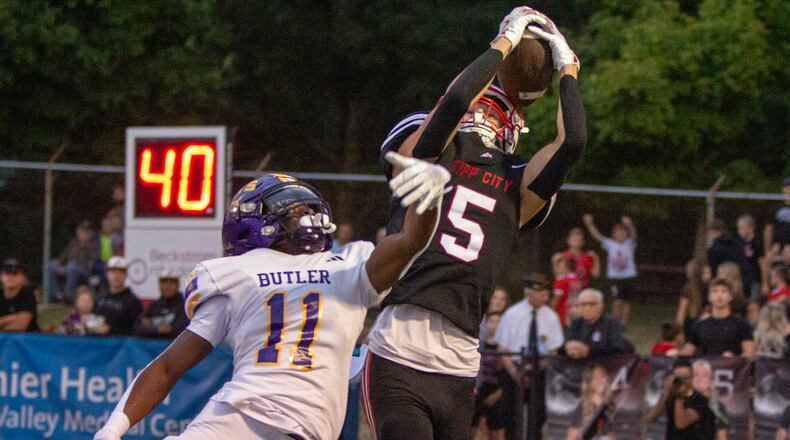 Tippecanoe's Dylan Herndon catches a pass over Vandalia Butler's Davon Smith during the first half of Thursday night's game won by Tipp 25-7. Jeff Gilbert/CONTRIBUTED