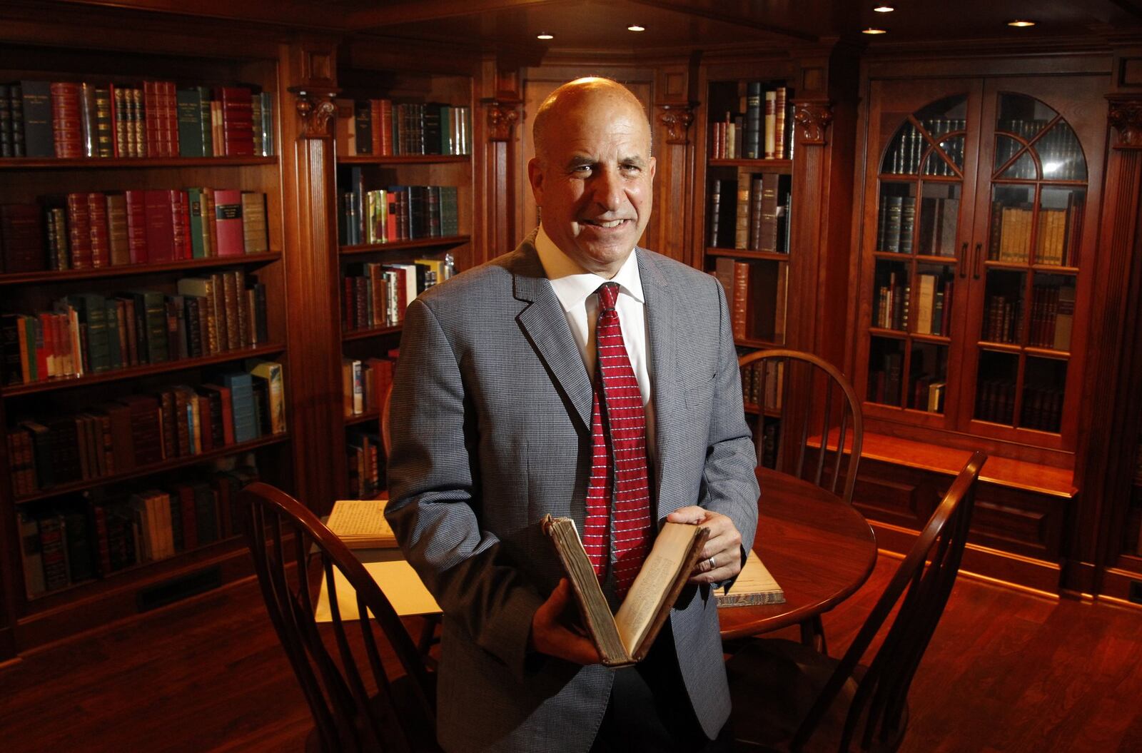 Stuart Rose of Springboro has a collection of some of the rarest books in the world. He has loaned some of his books to the University of Dayton for an exhibit, “Imprints and Impressions: Milestones in Human Progress,” which runs through Nov. 9 in the Roesch Library first floor gallery. LISA POWELL / STAFF