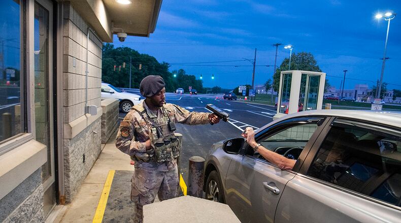 Senior Airman D’Mario Woodward scans an ID card as a driver enters Gate 15A at Wright-Patterson Air Force Base. U.S. AIR FORCE PHOTO/R.J. ORIEZ
