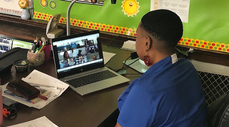 Emerson Academy third-grade teacher Michelle Saunders has a live session with her students through her laptop computer on Wednesday, Aug. 12, 2020 in Dayton.
