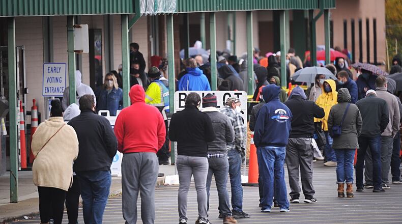 The rain and the cold weather on Friday, Oct. 30, 2020, did not stop voters in Greene County from lining up to vote early in Xenia. MARSHALL GORBY\STAFF