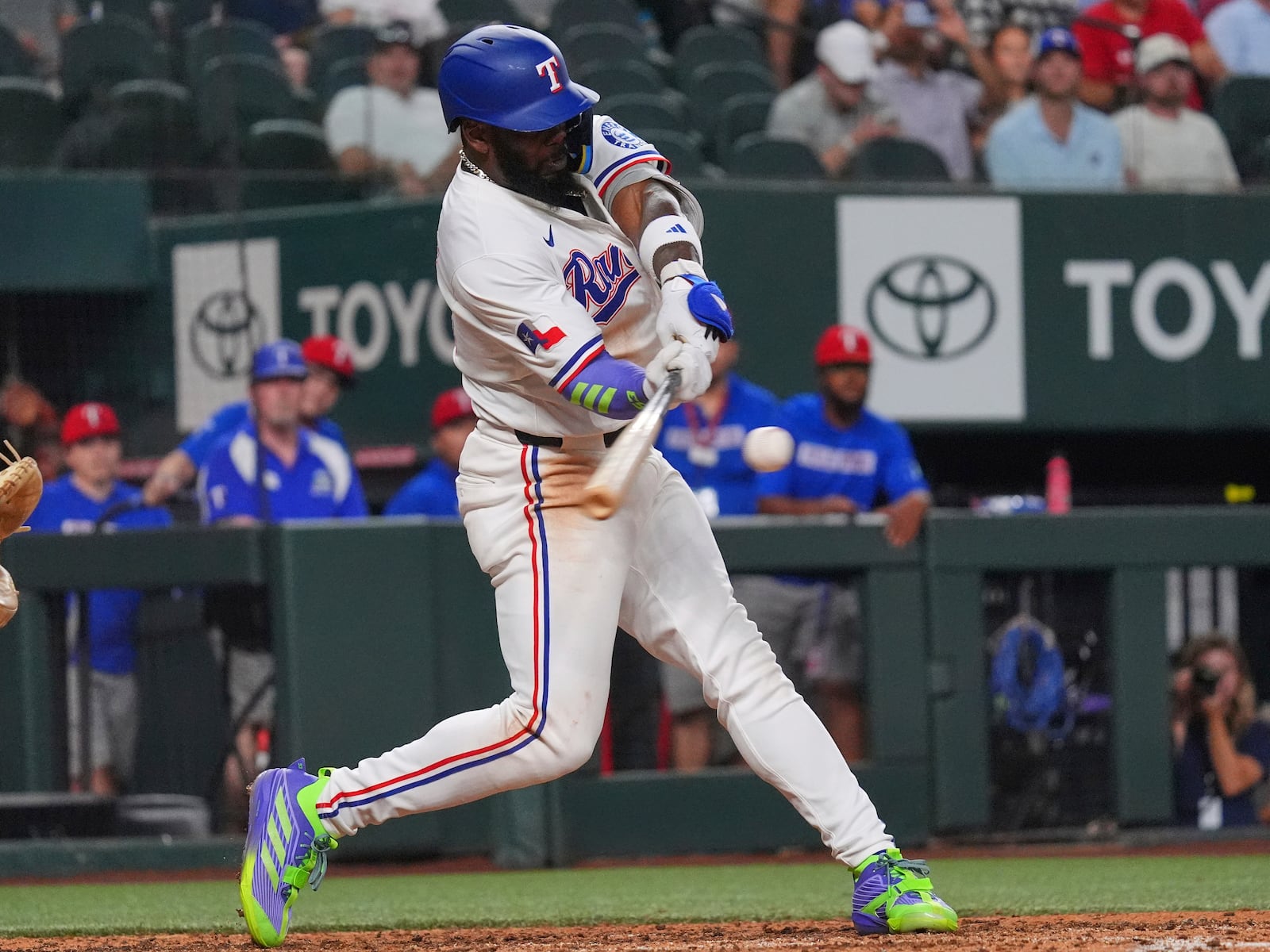 Texas Rangers' Adolis García hits a home run during the sixth inning of a baseball game against the Colorado Rockies, Wednesday, May 14, 2025, in Arlington, Texas. (AP Photo/LM Otero)