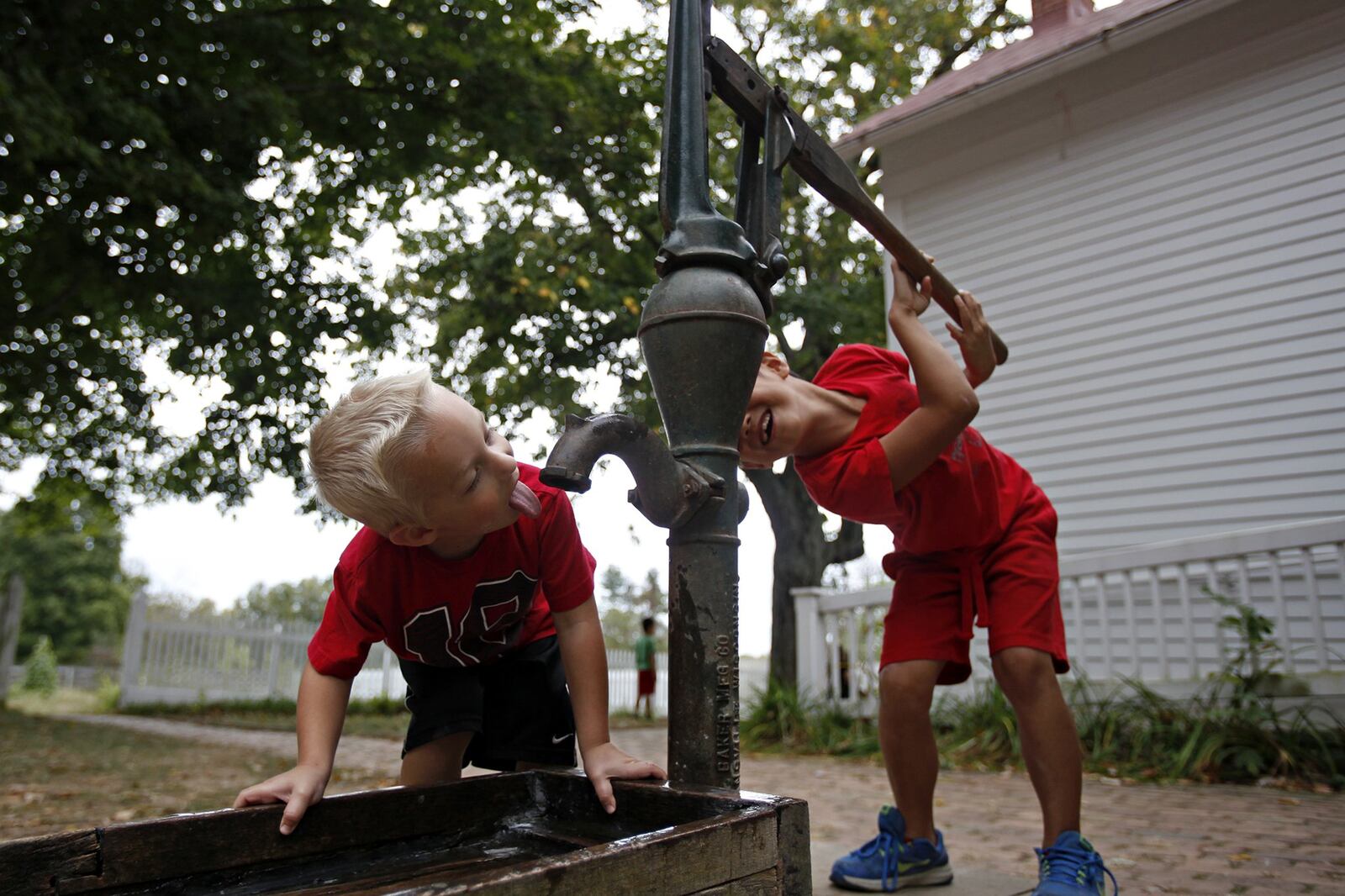 These boys play with a water pump at Slate Run Historical Farm in Canal Winchester. LEAH KLAFCZYNSKI/THE COLUMBUS DISPATCH