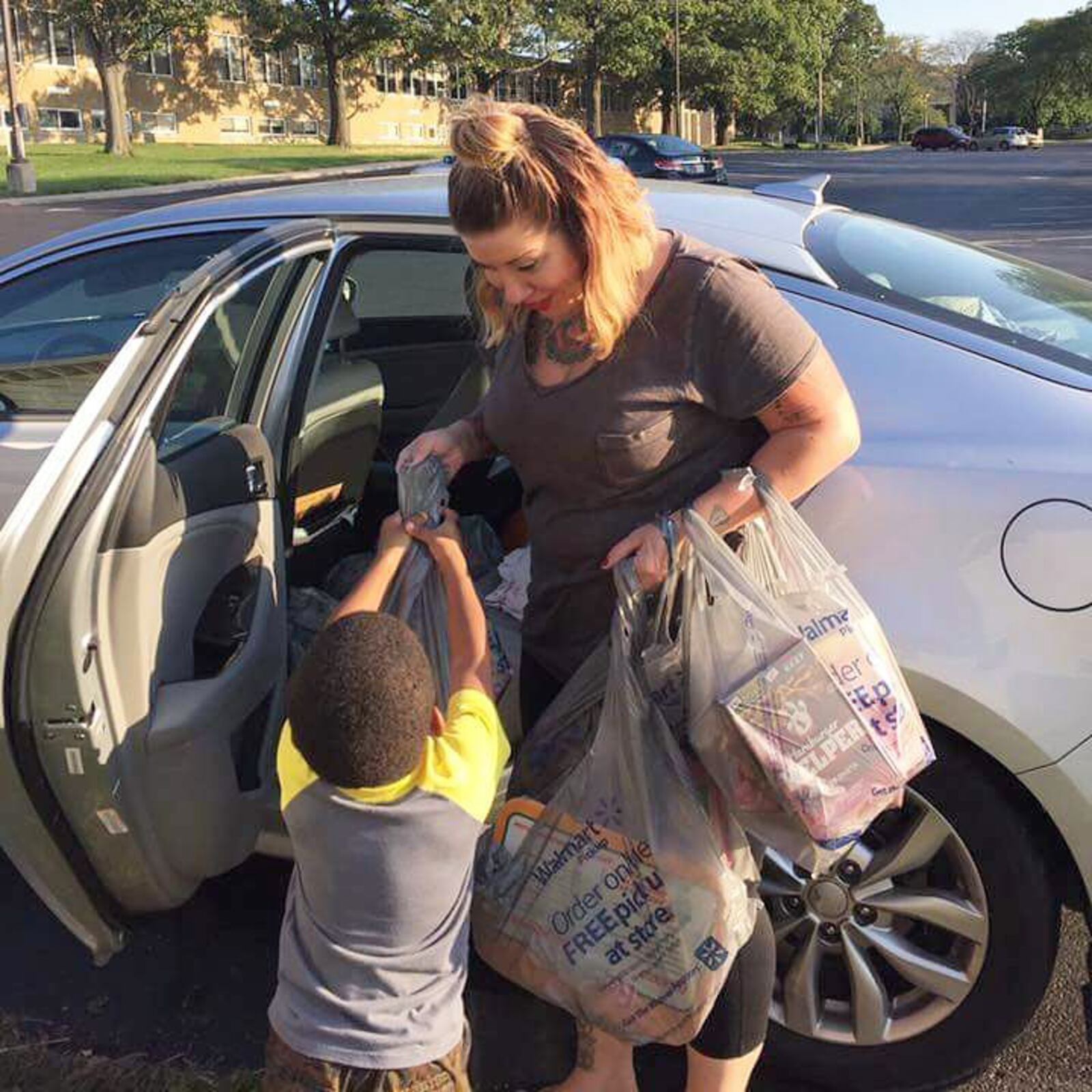 Daytonian of the Week, Shana Lloyd uses 10% of her photography session fees to give back to the community. Here she is delivering food and necessities to the Mustard Seed Home. CONTRIBUTED