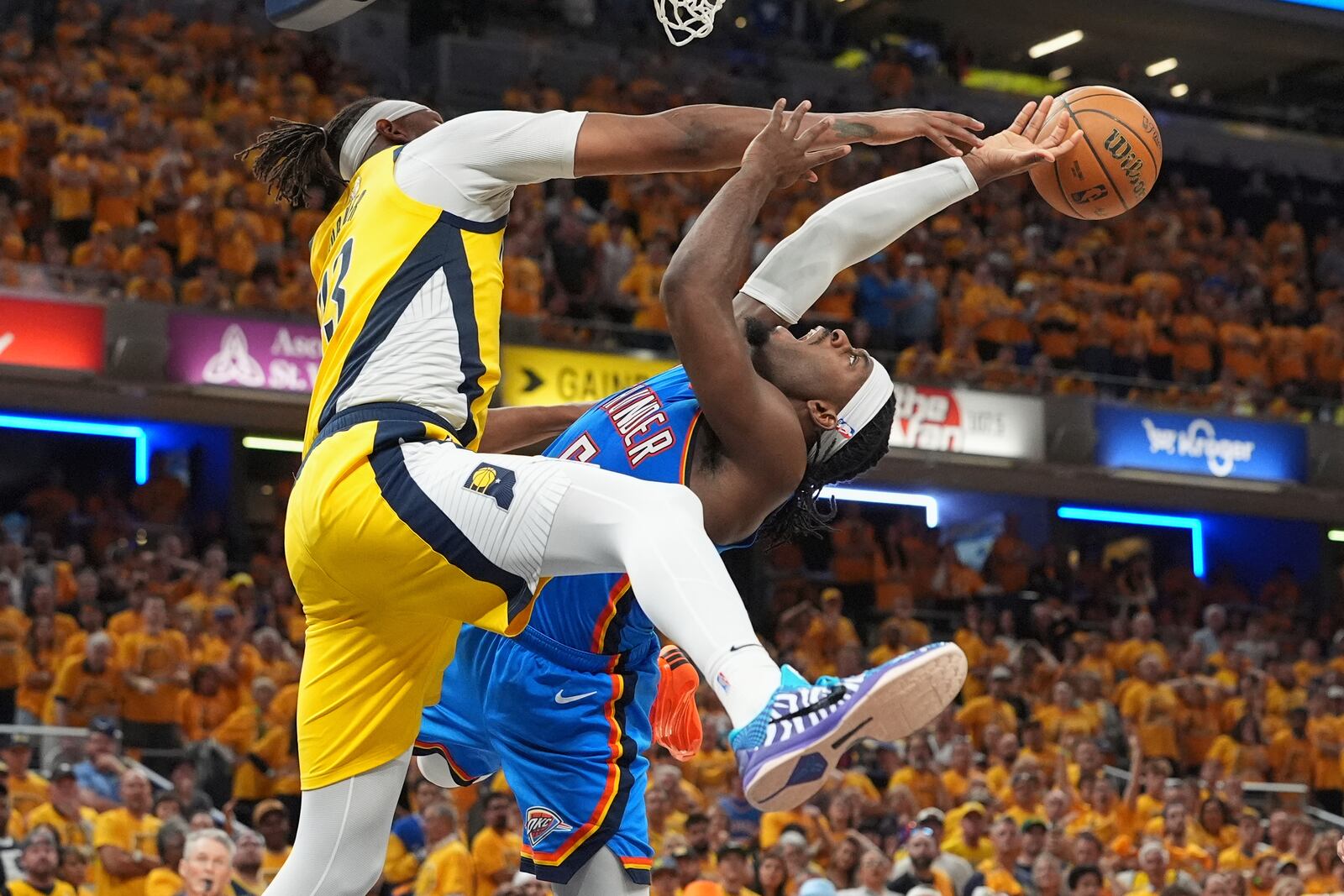 Oklahoma City Thunder guard Luguentz Dort, right, tries to shoot over Indiana Pacers center Myles Turner during the second half of Game 4 of the NBA Finals basketball series, Friday, June 13, 2025, in Indianapolis. (AP Photo/Michael Conroy)