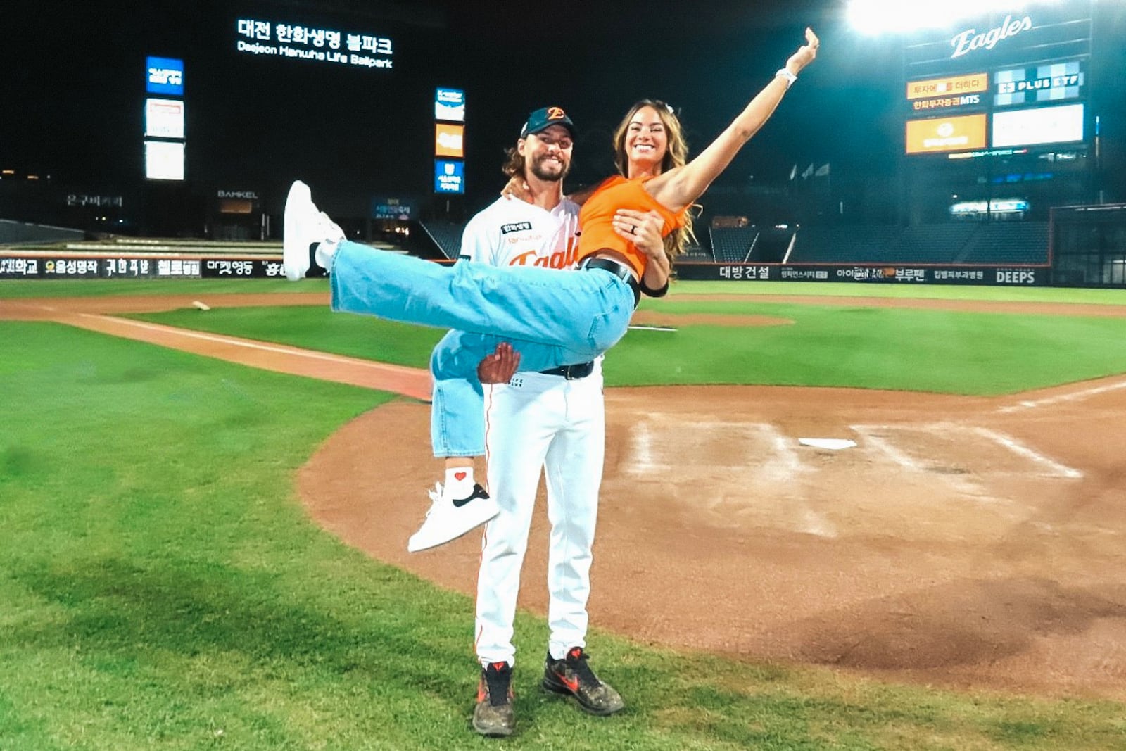 Ryan Weiss and his wife Hailey Brooke celebrate a victory after a game at Daejeon Hanwha Life Ballpark. CONTRIBUTED PHOTO