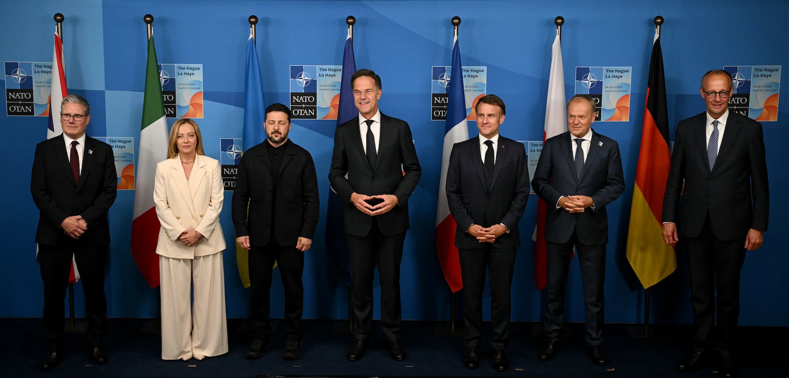 Britain's Prime Minister Keir Starmer, from left, Italy's Prime Minister Giorgia Meloni, Ukraine's President Volodymyr Zelenskyy, NATO Secretary General Mark Rutte, France's President Emmanuel Macron, Poland's Prime Minister Donald Tusk and Germany's Chancellor Friedrich Merz pose for a family picture during the meeting between the Nato secretary general and Ukrainian president with leaders of E5 Group on the sideline of the NATO summit in The Hague, Netherlands, Wednesday, June 25, 2025. (Ben Stansall/Pool Photo via AP)
