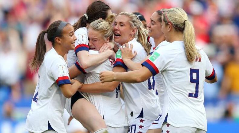 Rose Lavelle celebrates with Emily Sonnett and USA teammates following the 2019 FIFA Women's World Cup France Final match between the United States and the Netherlands at Stade de Lyon on July 07, 2019, in Lyon, France. (Photo by Richard Heathcote/Getty Images)