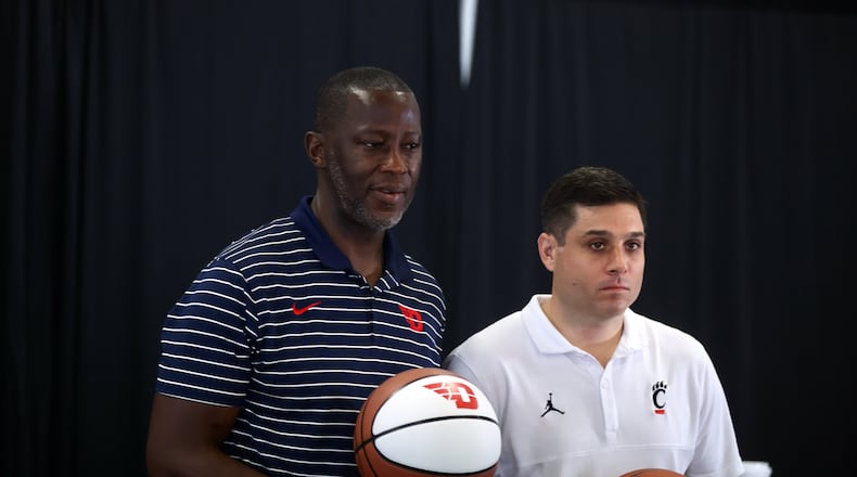 Dayton coach Anthony Grant and Cincinnati coach Wes Miller pose for a photo at a press conference where the Hoops Classic game between UD and Cincinnati was announced on Wednesday, July 19, 2023, at the Heritage Bank Center in Cincinnati. The Flyers and Bearcats will play at the arena on Dec. 16. David Jablonski/Staff