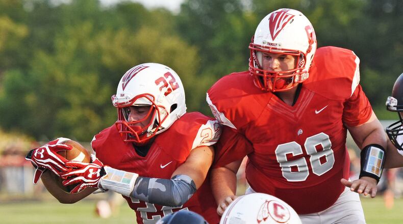 Carlisle’s Ridge Reed (22), with lineman Jordan Parrish (68) by his side, scores against Franklin in the 2015 season opener. NICK GRAHAM/STAFF