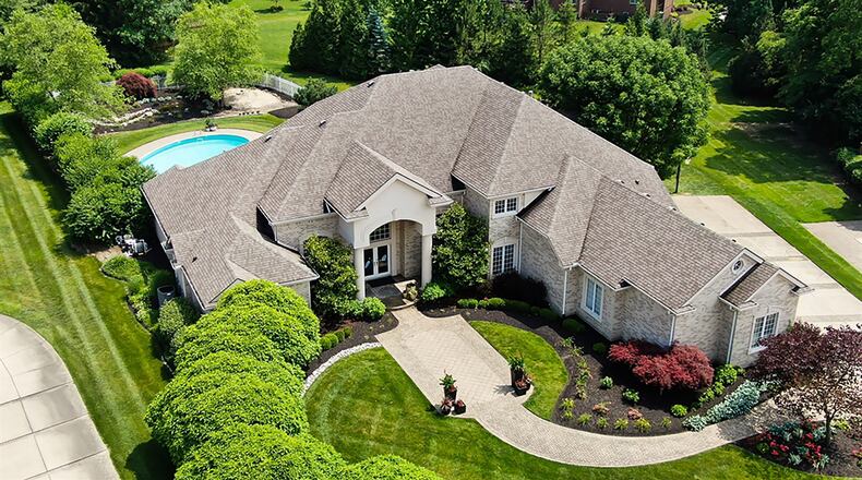 The sprawling brick estate has about 8,520 sq. ft. of living space, most of which is on the main level. The 1-acre property has a courtyard-like entrance patio and concrete drive to the 3-car garage. CONTRIBUTED PHOTO