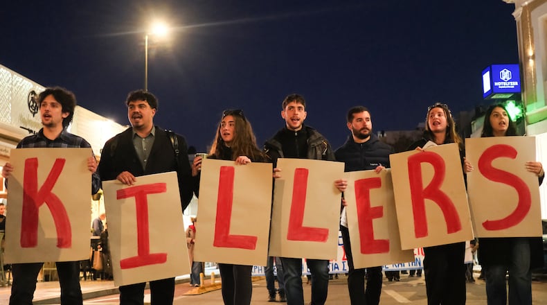 Protesters take part in an anti-war rally in Chania, Greece, opposing the docking of the aircraft carrier USS Gerald R. Ford at the nearby Souda Bay naval base on the southern island of Crete, Tuesday, Feb. 24, 2026. (AP Photo/Giannis Angelakis)
