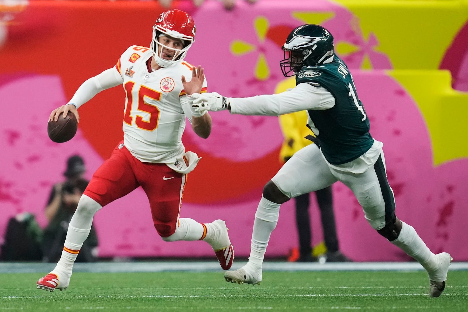 FILE - Kansas City Chiefs quarterback Patrick Mahomes (15) eludes the reach of Philadelphia Eagles linebacker Josh Sweat during the second half of the NFL Super Bowl 59 football game on Feb. 9, 2025, in New Orleans. (AP Photo/Ashley Landis, File)