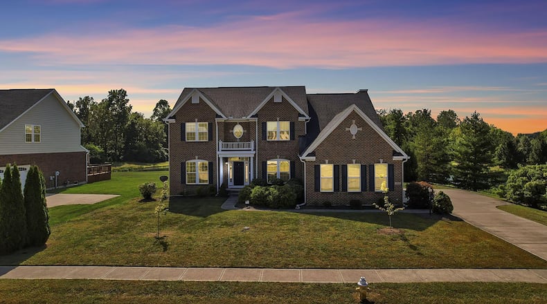 This brick and vinyl three story home sits on a finished walk out basement and overlooks a pond.
