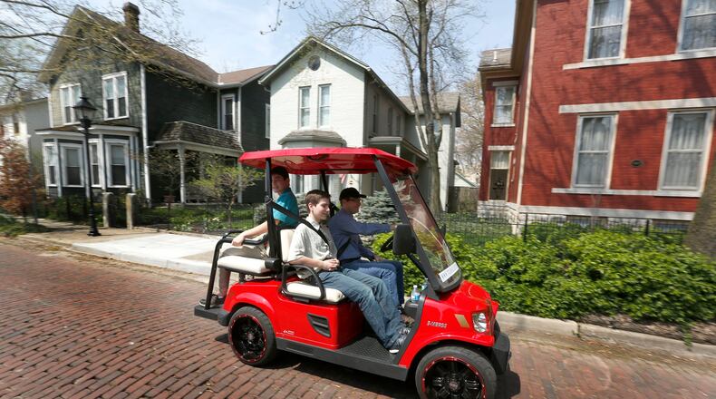 Council members are exploring ways to allow residents to drive golf carts on certain Huber Heights roads. This 2017 file photo shows a group of entrepreneurs who started a business taking visitors on golf cart tours through many Dayton neighborhoods. LISA POWELL / STAFF