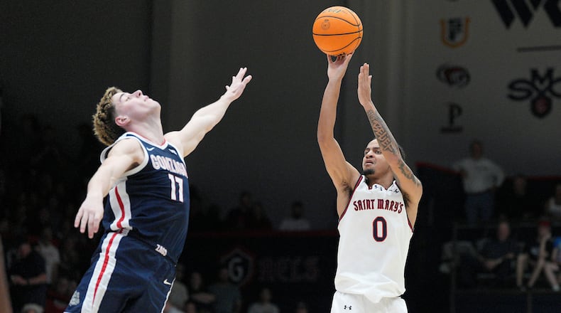 Saint Mary's guard Mikey Lewis (0) shoots over Gonzaga guard Mario Saint-Supery (17) during the second half of an NCAA college basketball game in Moraga, Calif., Saturday, Feb. 28, 2026. (AP Photo/Tony Avelar)