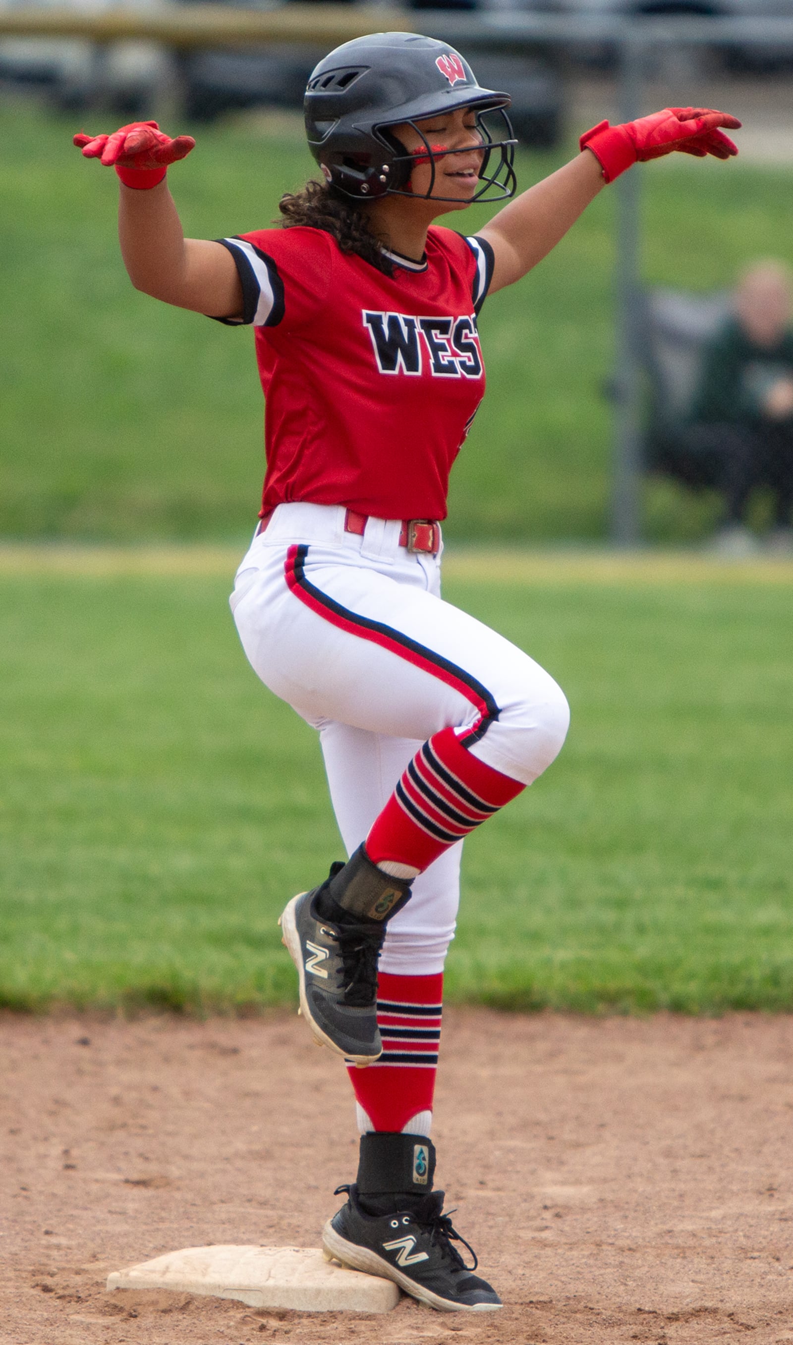 Lakota West's Mia Anderson celebrates a double during the Firebirds' 8-1 loss to Centerville in a Division I district final Thursday at Kings High School. JEFF GILBERT / CONTRIBUTED