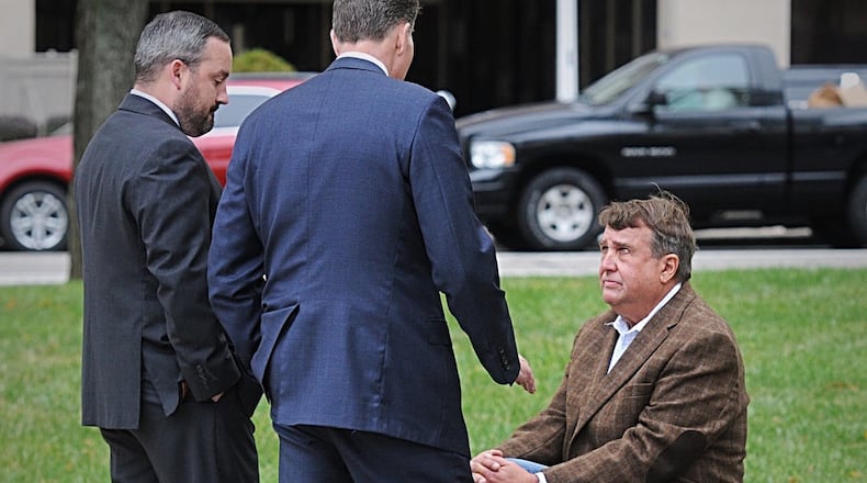 Steve Rauch (seated) confers with his attorneys prior to an earlier court appearance. MARSHALL GORBY/STAFF