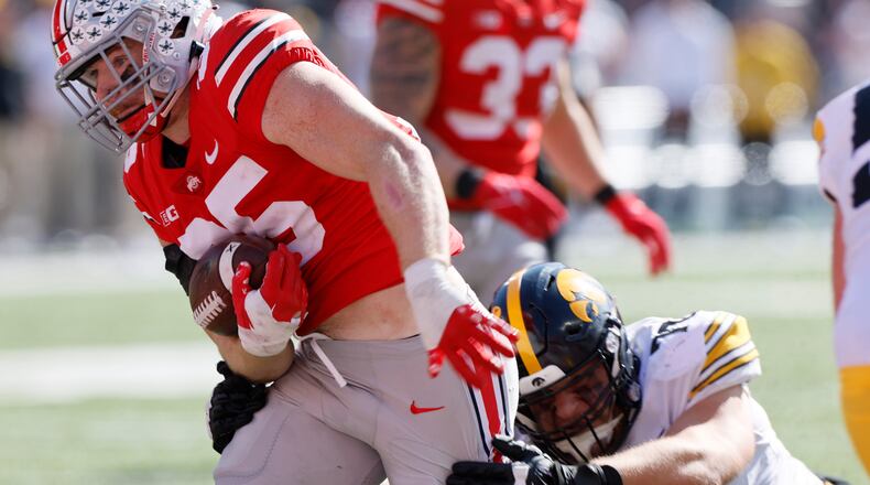 Ohio State linebacker Tommy Eichenberg, left, scores a touchdown after intercepting a pass against Iowa during the first half of an NCAA college football game Saturday, Oct. 22, 2022, in Columbus, Ohio. (AP Photo/Jay LaPrete)
