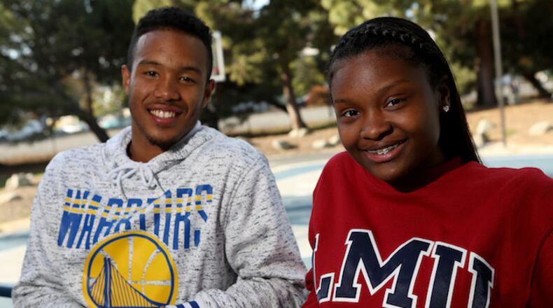 Boys and Girls Club of the Peninsula 2018 Youth of the Year recipients Alysia Demery, 17, and Dezmond Fraiser, 17, from left, pose for a photograph in front of the basketball court donated by Golden State Warriors forward Kevin Durant in Redwood City, Calif., on Friday, April 27, 2018. Durant recently announced he will help pay a portion of both Demery and Fraiser's college education. (Anda Chu/Bay Area News Group/TNS)