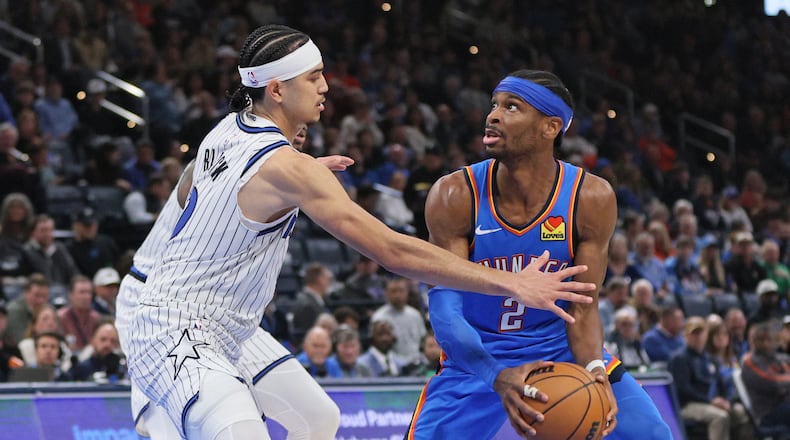 Oklahoma City Thunder guard Shai Gilgeous-Alexander (2) looks for an outlet against Orlando Magic guard Anthony Black, left, during the second half of an NBA basketball game, Tuesday, Feb. 3, 2026, in Oklahoma City. (AP Photo/Nate Billings)