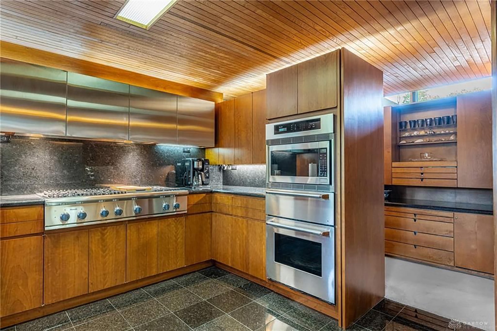 the kitchen has high end appliances, a wood plank ceiling and marble floors. CONTRIBUTED