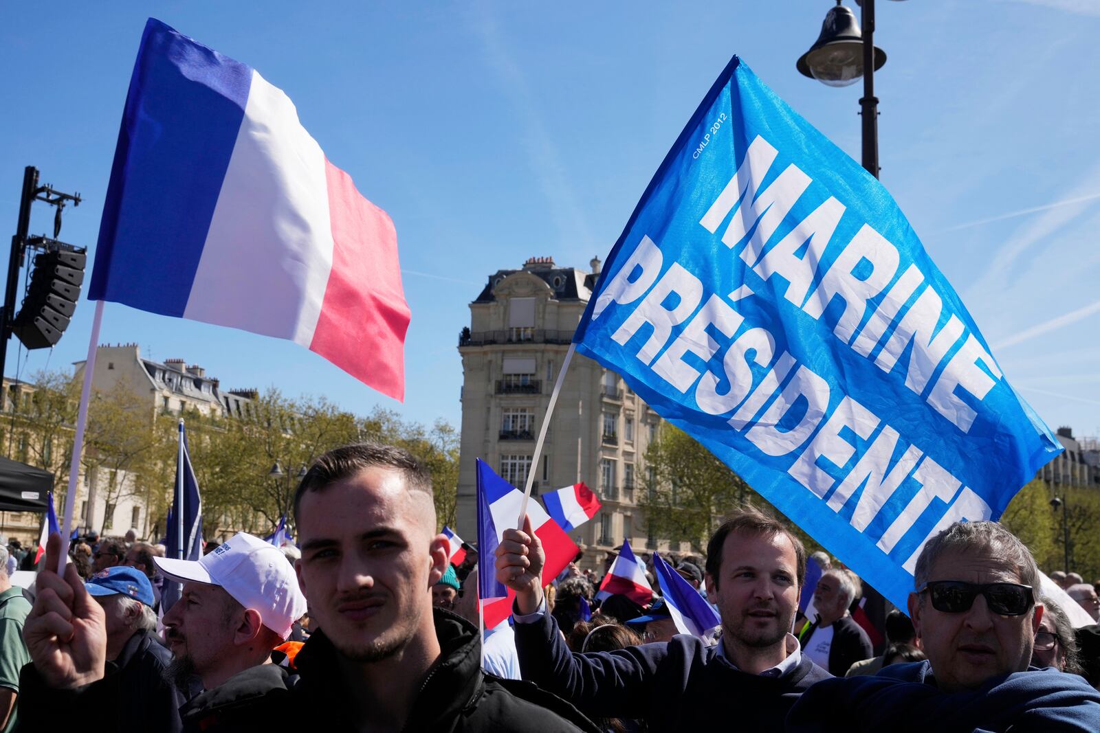 People attend at the French far-right party national rally near the parliament in support of Marine Le Pen, in Paris, Sunday, April 6, 2025. (AP Photo/Michel Euler)
