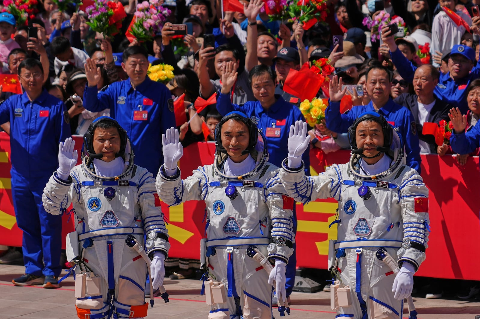 Chinese astronauts for the Shenzhou 20 mission, from right, Chen Zhongrui, Chen Dong and Wang Jie wave as they attend a send-off ceremony for their manned space mission at the Jiuquan Satellite Launch Center in northwestern China, Thursday, April 24, 2025. (AP Photo/Andy Wong)