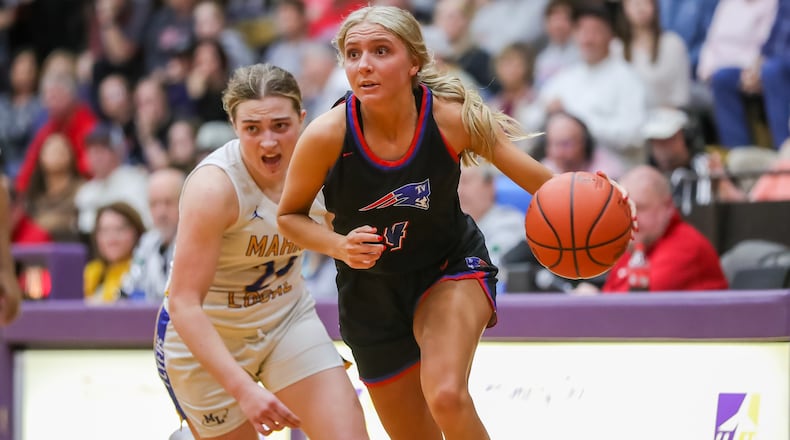 Tri-Village High School senior Rylee Sagester drives past Marion Local sophomore Chloe Ronnebaum during their Division IV regional semifinal game at the Vandalia Butler Student Activity Center. Michael Cooper/CONTRIBUTED