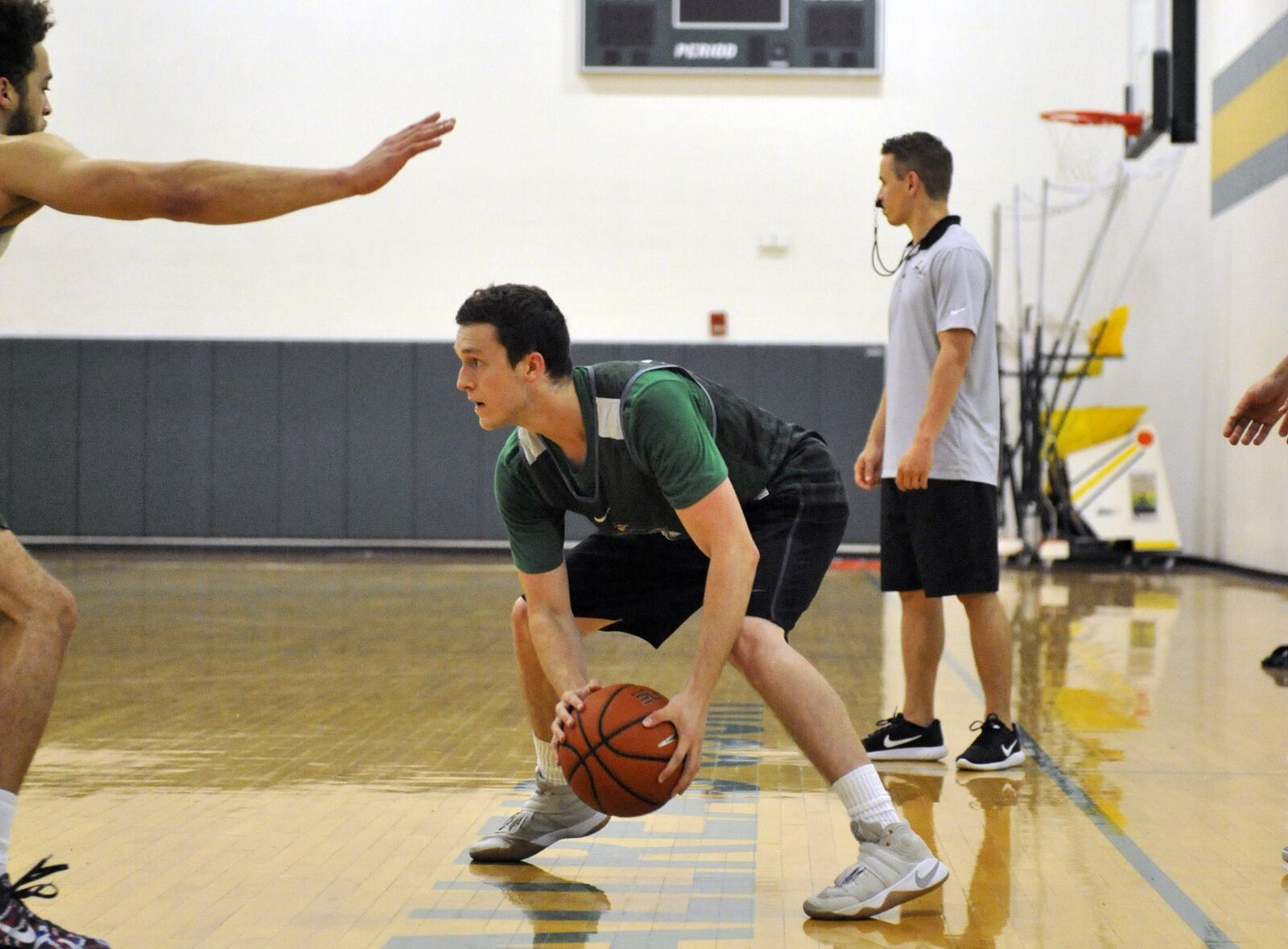 Wright State freshman Tyler Mitchell looks for a passing lane during summer practice Thursday at the Setzer Pavilion.