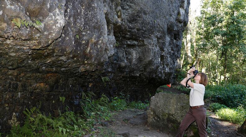 Carol Kennard, executive director of the Clark County Park District, takes photos of the Mad River Gorge climbing area. The Clark County Park District has recently purchased Mad River Gorge and pulled over 125,000 pounds of trash from the gorge, but they still have more to go. Leave No Trace Behind has chosen the gorge as one of 15 hot spots in the country to assist with this process. Bill Lackey/Staff