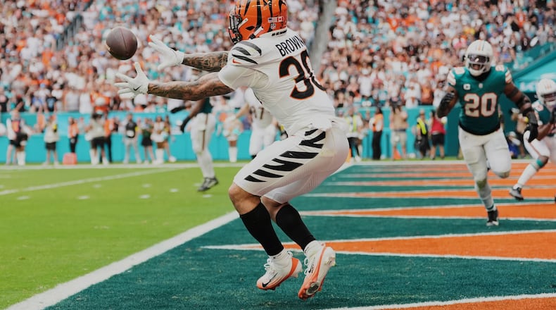 Cincinnati Bengals running back Chase Brown catches a pass for a touchdown during the second half of an NFL football game against the Miami Dolphins, Sunday, Dec. 21, 2025, in Miami Gardens, Fla. (AP Photo/Rebecca Blackwell)