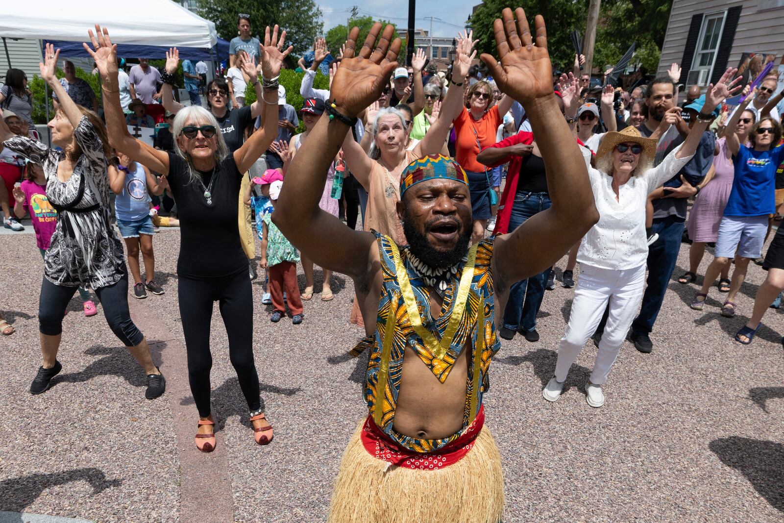 Nii Osenda of the Akwaaba Ensemble leads people in dance during a Juneteenth celebration at the African Burying Ground Memorial Park Thursday, June 19, 2025, in Portsmouth, N.H. (AP Photo/Michael Dwyer)