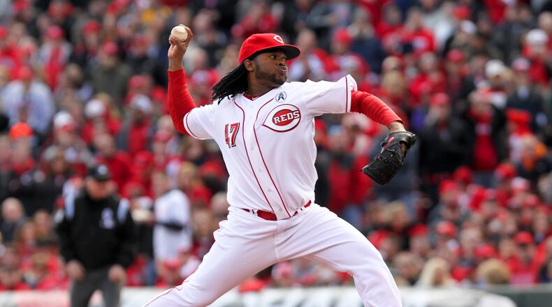Reds starting pitcher Johnny Cueto delivers the first pitch of the Reds season during their opening day game against the Angels at Great American Ball Park, Monday, April 1, 2013. GREG LYNCH / STAFF