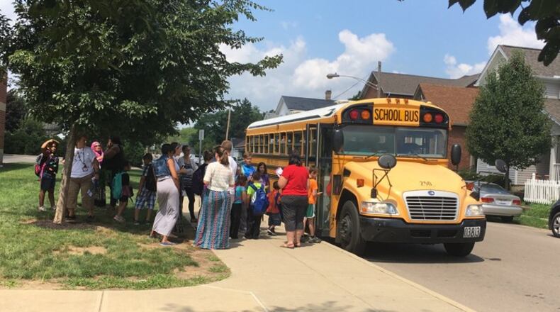 Students board a school bus outside Dayton’s Ruskin Elementary. JEREMY P. KELLEY / STAFF