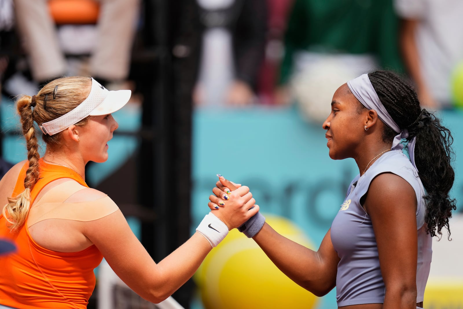 United States' Coco Gauff, right, shakes hands after her victory Mirra Andreeva of Russia at the Madrid Open quarter-final tennis match in Madrid, Spain, Wednesday, April 30, 2025. (AP Photo/Manu Fernandez)