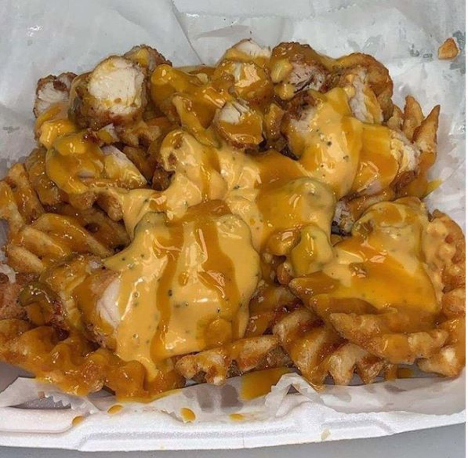 Chicken Spots' loaded fries comes with a list of sloppy toppings that can includes   choice of two sauces, chopped chicken tenders, crispy bacon, shredded romaine lettuce, chopped tomatoes and pickled onions. Mac and cheese and greens can be added for  $2 each.