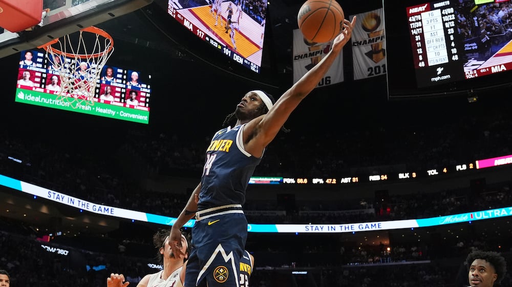 Denver Nuggets forward Daron Holmes II (14) loses control of the ball during the second half of an NBA basketball game against the Miami Heat, Monday, Dec. 29, 2025, in Miami. (AP Photo/Lynne Sladky)