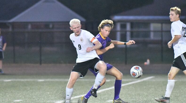 Beavercreek senior Jack Towers (No. 9) battles for control of the ball during a match with Butler. Greg Billing / Contributed