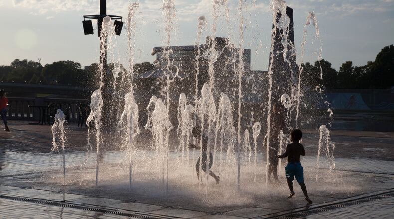 Child playing in interactive fountain at RiverScape MetroPark.