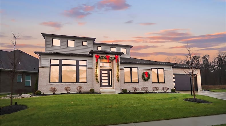 The front of this contemporary style two story has a concrete driveway, a covered front entry and a two car attached garage. CONTRIBUTED