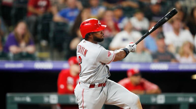 Cincinnati Reds' Phillip Ervin watches his RBI triple off Colorado Rockies starting pitcher Kyle Freeland during the third inning of a baseball game Saturday, July 13, 2019, in Denver. (AP Photo/David Zalubowski)