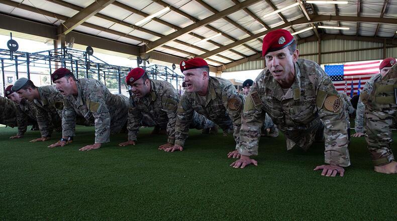 Members of the Special Warfare Training Wing honor the fallen with memorial push-ups after the SWTW activation ceremony at Joint Base San Antonio-Medina Base, Texas, Oct. 10. The mission of the new wing is to select, train, equip and mentor Airmen to conduct global combat operations in contested, denied, operationally limited, and permissive environments under any environmental conditions. (U.S. Air Force photo/Andrew C. Patterson)