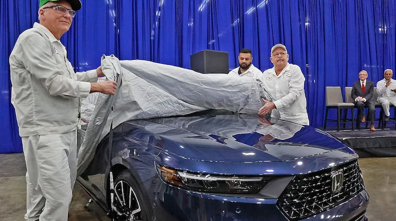 Honda associates Rick VanGundy, left, and Mike Rausch, right, unveil the new 2023 Honda Accord as Gov. Mike DeWine looks on in the background Thursday, Jan. 5, 2023. Both VanGunday and Rausch have worked at the Honda Marysville Plant since it opened. BILL LACKEY/STAFF