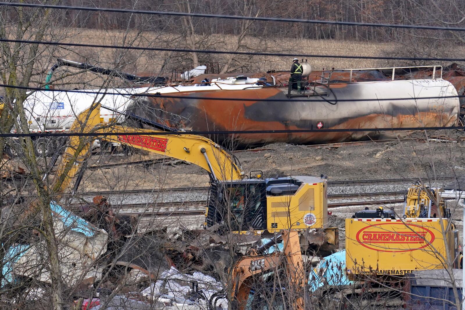 Workers continue to clean up remaining tank cars, Tuesday, Feb. 21, 2023, in East Palestine, Ohio, following the Feb. 3 Norfolk Southern freight train derailment. (AP Photo/Matt Freed)