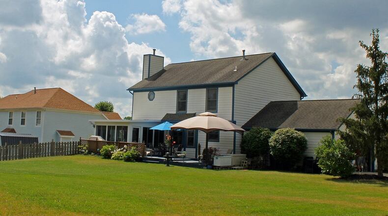 A wide doorway in the living room connects with the open concept family room, breakfast nook and kitchen. The family room features sliding glass doors that open to the sunroom.