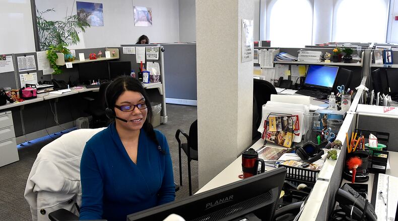 Tiffany Brown, an employee at the Red Roof Inn call center in Springfield, works at her desk taking calls from customers./Bill Lackey